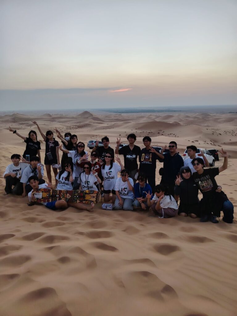 Morning Dubai Desert Safari with golden dunes, clear skies, and adventure activities including dune bashing and camel rides.